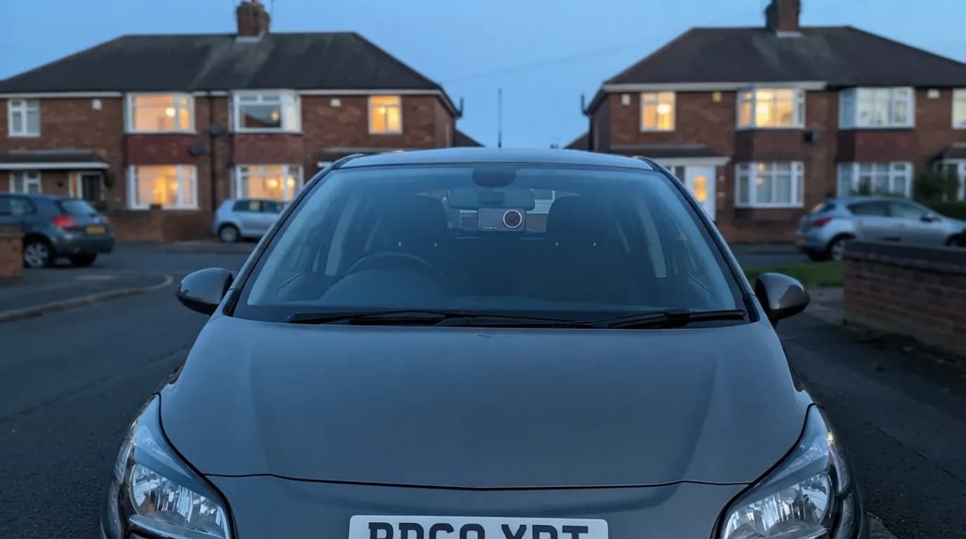 A car parked on a quiet street at dusk, the Halden Duo 4K behind the mirror